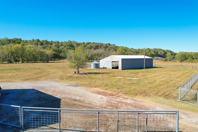 view of yard with an outbuilding and a rural view