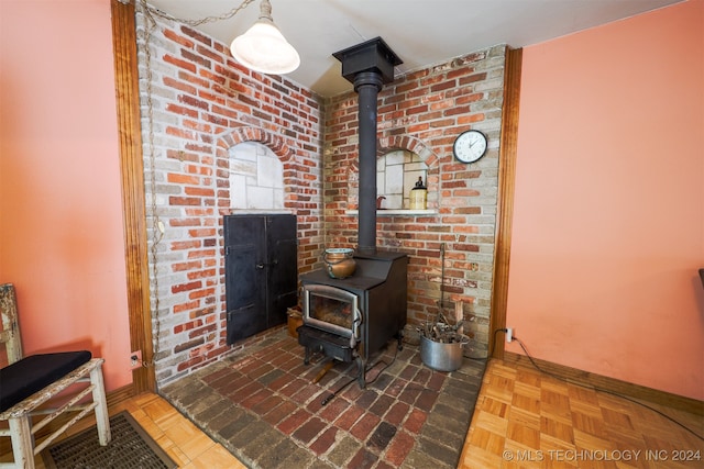 interior details with parquet flooring and a wood stove