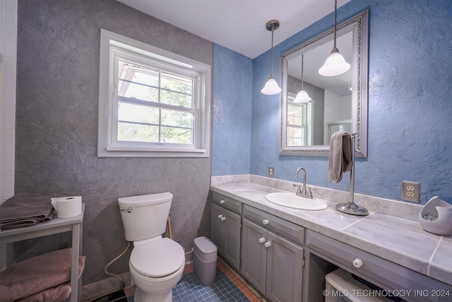 bathroom featuring vanity, toilet, and tile patterned floors