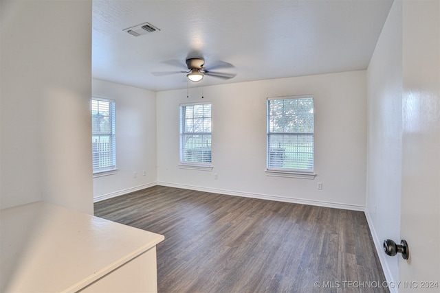 unfurnished room with dark wood-type flooring and ceiling fan