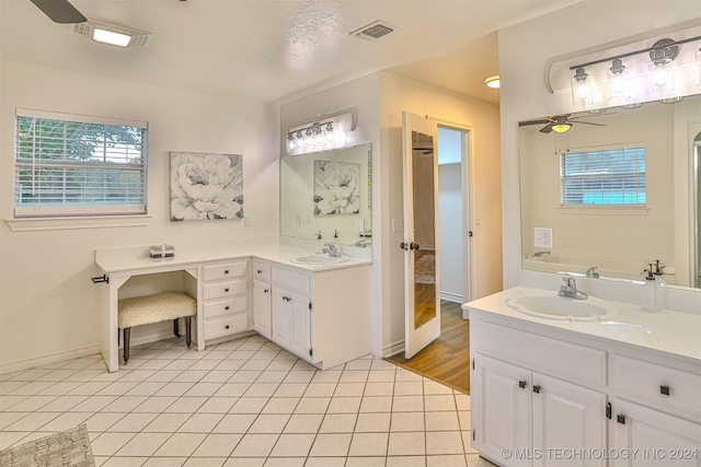 bathroom featuring vanity, ceiling fan, a textured ceiling, and tile patterned flooring