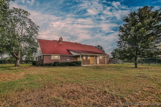 rear view of house with a yard