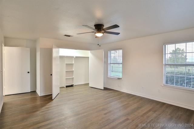 unfurnished bedroom featuring a closet, dark hardwood / wood-style floors, and ceiling fan