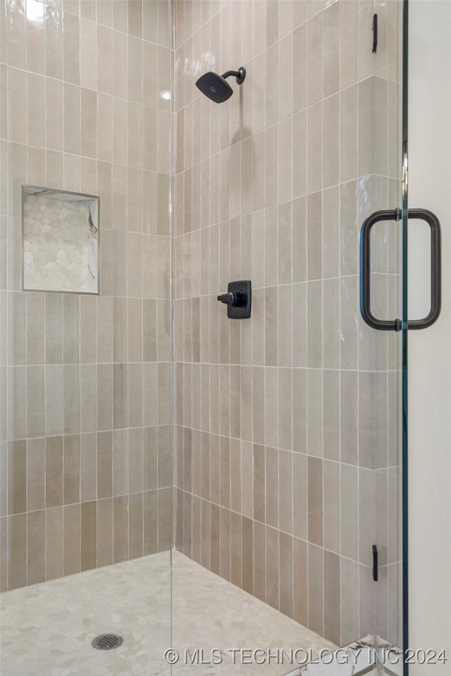 bathroom with a shower with shower door