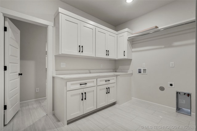 washroom featuring cabinets, washer hookup, and electric dryer hookup