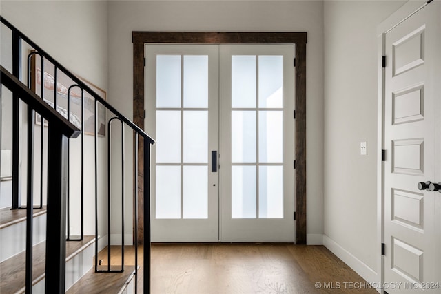 entryway with french doors and light hardwood / wood-style flooring