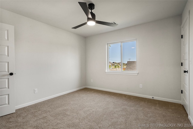 spare room with carpet flooring and ceiling fan