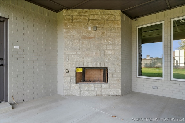 view of patio / terrace featuring an outdoor stone fireplace