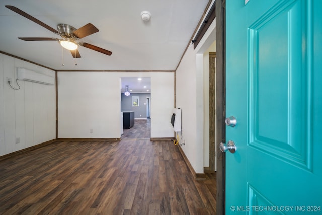 entryway featuring a wall mounted AC, heating unit, ceiling fan, ornamental molding, and dark hardwood / wood-style floors