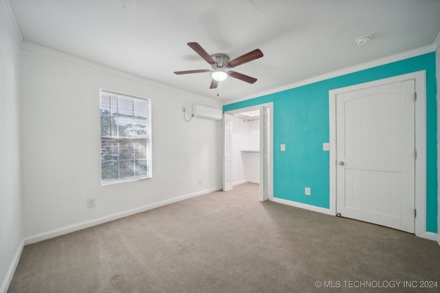 unfurnished bedroom with ornamental molding, a wall mounted AC, carpet flooring, and ceiling fan