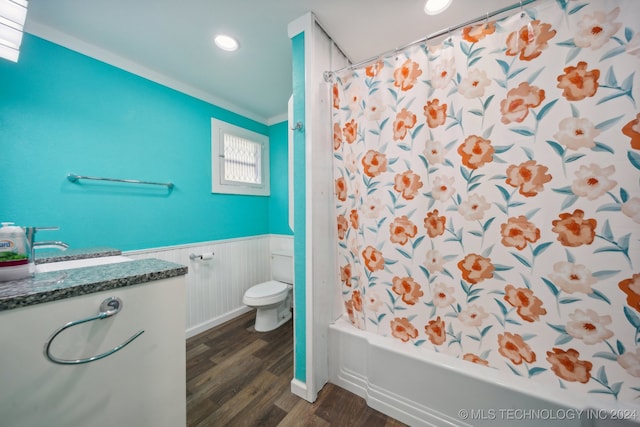 full bathroom featuring toilet, ornamental molding, hardwood / wood-style floors, shower / tub combo with curtain, and vanity