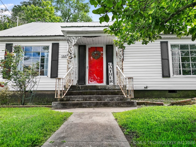 doorway to property featuring a yard