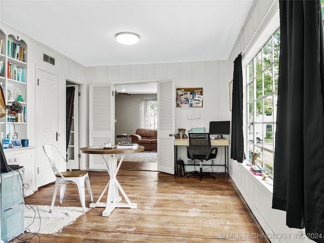 office with hardwood / wood-style floors and plenty of natural light