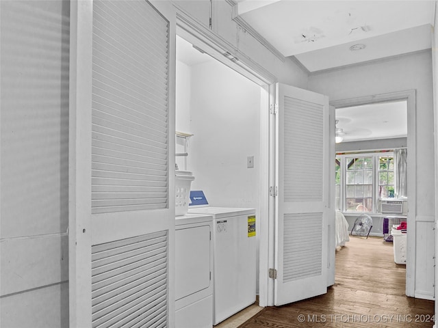 clothes washing area with dark hardwood / wood-style floors and washing machine and clothes dryer