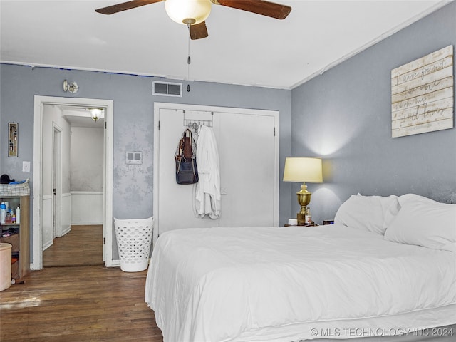 bedroom featuring dark hardwood / wood-style floors, a closet, and ceiling fan