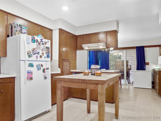 kitchen featuring white fridge and an inviting chandelier