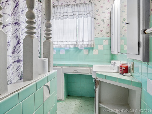 bathroom featuring sink, tile walls, and tile patterned flooring