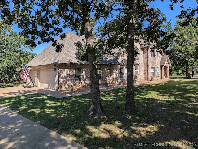 view of front of property with a front yard and a garage