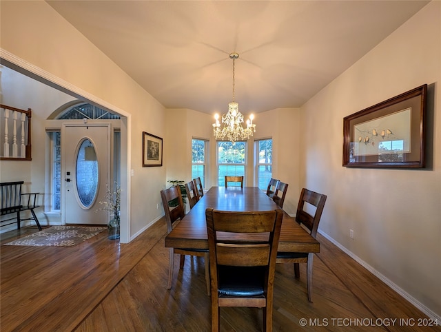 dining space featuring a notable chandelier and dark hardwood / wood-style flooring