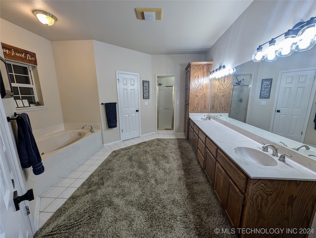 bathroom with vanity, shower with separate bathtub, and tile patterned floors