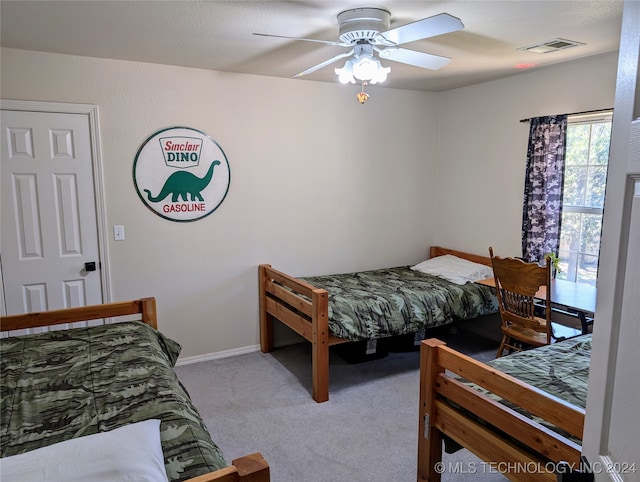 bedroom featuring light carpet and ceiling fan