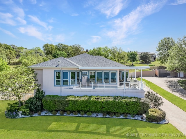 rear view of property featuring a yard