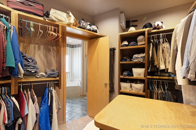 spacious closet with light tile patterned floors