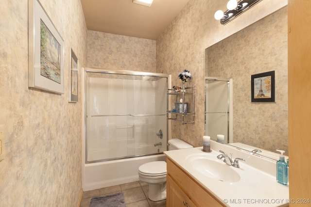 full bathroom with vanity, shower / bath combination with glass door, toilet, and tile patterned flooring