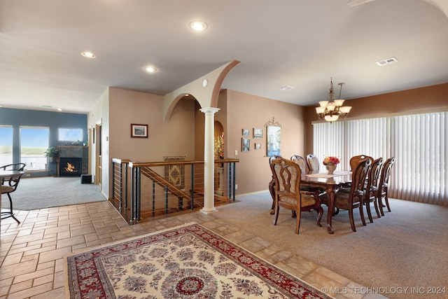 carpeted dining space with a notable chandelier