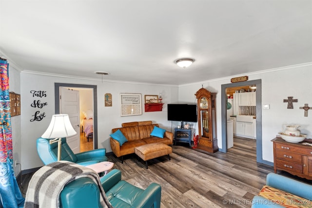 living room with crown molding and hardwood / wood-style flooring