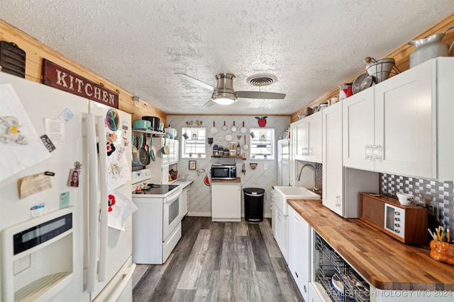 kitchen featuring white cabinetry, wood counters, wood walls, dark wood-type flooring, and white appliances