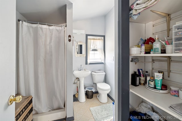 bathroom with curtained shower and toilet