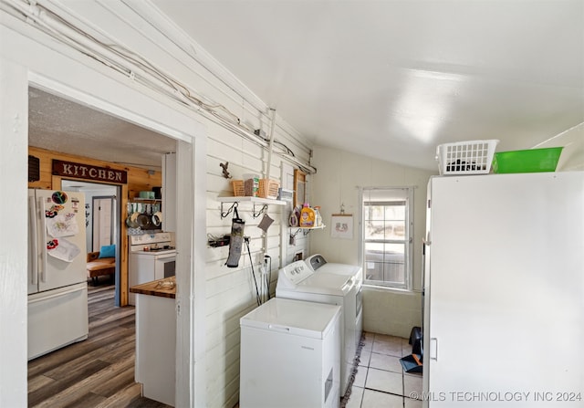 washroom with separate washer and dryer and dark hardwood / wood-style flooring