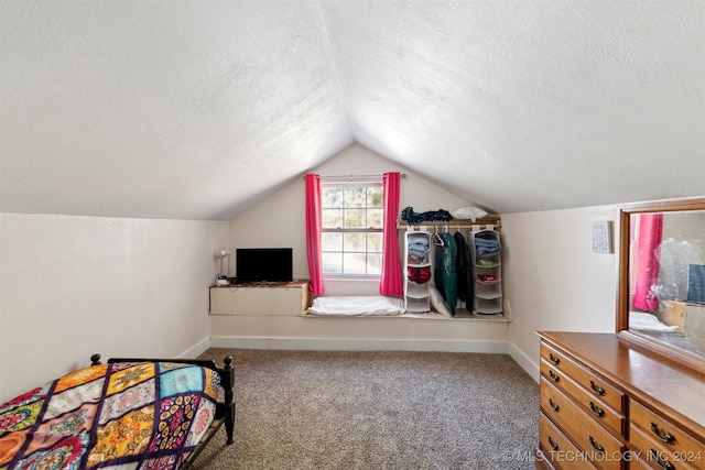 carpeted bedroom featuring lofted ceiling and a textured ceiling