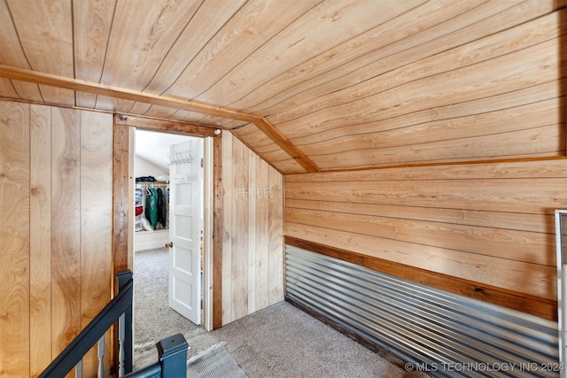 additional living space with carpet, vaulted ceiling, wood ceiling, and wooden walls