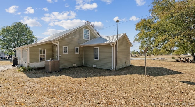 back of property featuring central AC