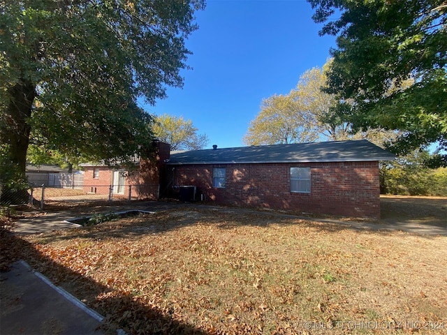 rear view of house with a lawn