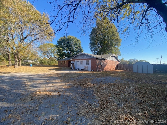 view of side of property featuring a storage unit