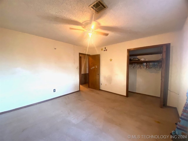 unfurnished bedroom with a textured ceiling, a closet, and ceiling fan