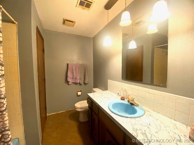 bathroom with vanity, a shower, decorative backsplash, toilet, and a textured ceiling