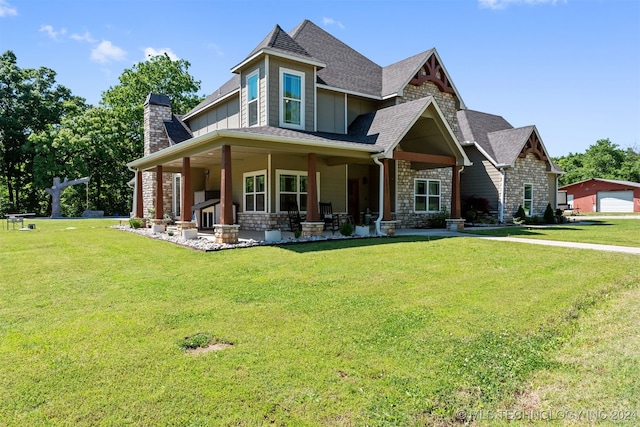 view of front of property with a front yard, a garage, and covered porch