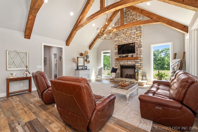 living room featuring a fireplace, hardwood / wood-style flooring, high vaulted ceiling, and plenty of natural light