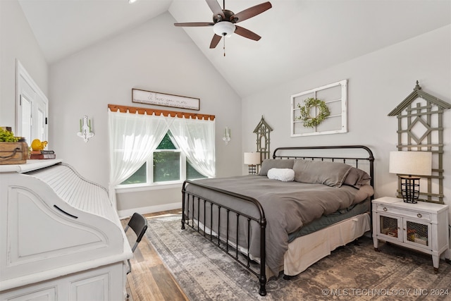 bedroom featuring dark hardwood / wood-style floors, high vaulted ceiling, and ceiling fan