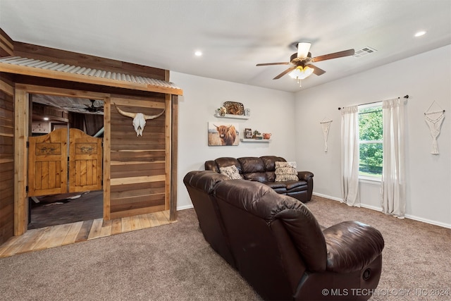 carpeted living room featuring ceiling fan