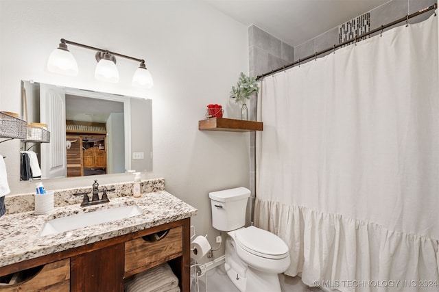 bathroom with vanity, toilet, and walk in shower