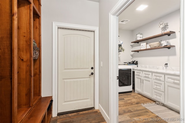 interior space with dark wood-type flooring and washer / clothes dryer