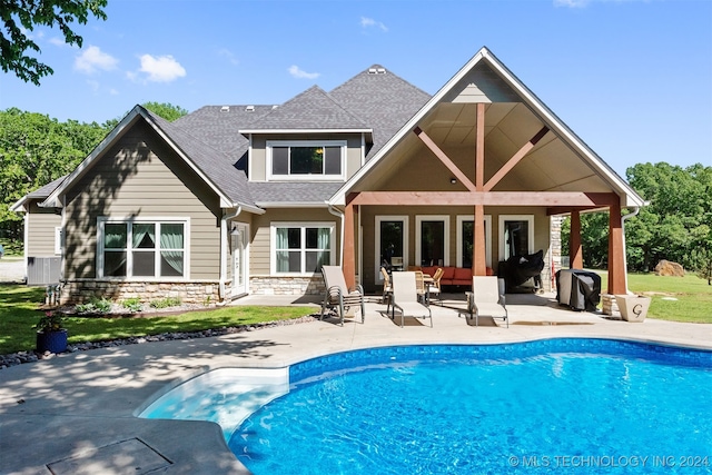 rear view of house with an outdoor hangout area and a patio area