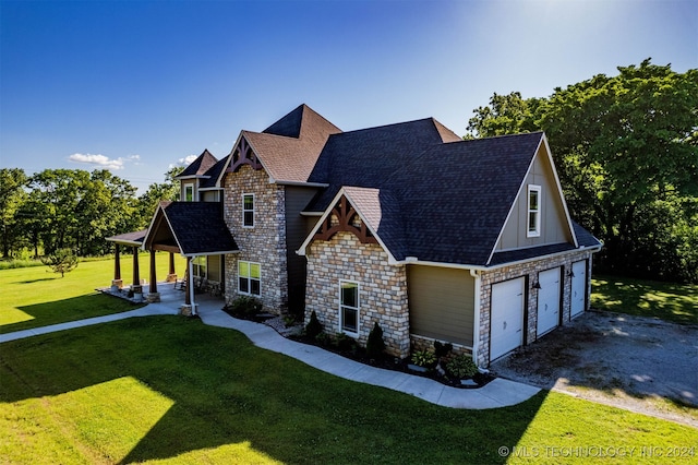 view of front of house with a garage and a front lawn