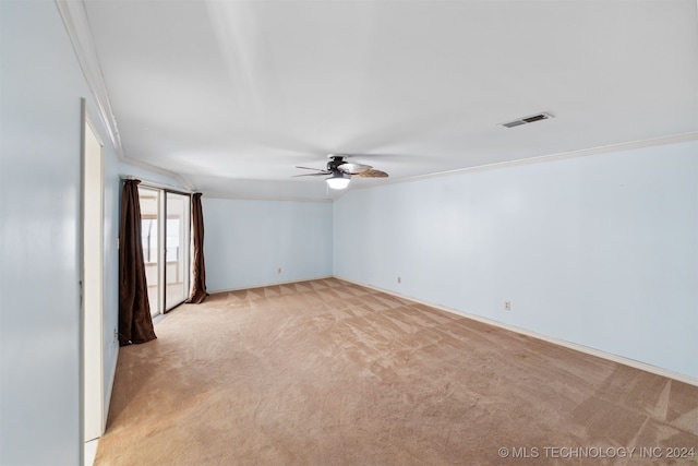 carpeted empty room featuring ceiling fan and crown molding