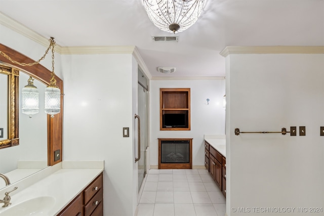 bathroom featuring a notable chandelier, a shower with shower door, vanity, crown molding, and tile patterned floors